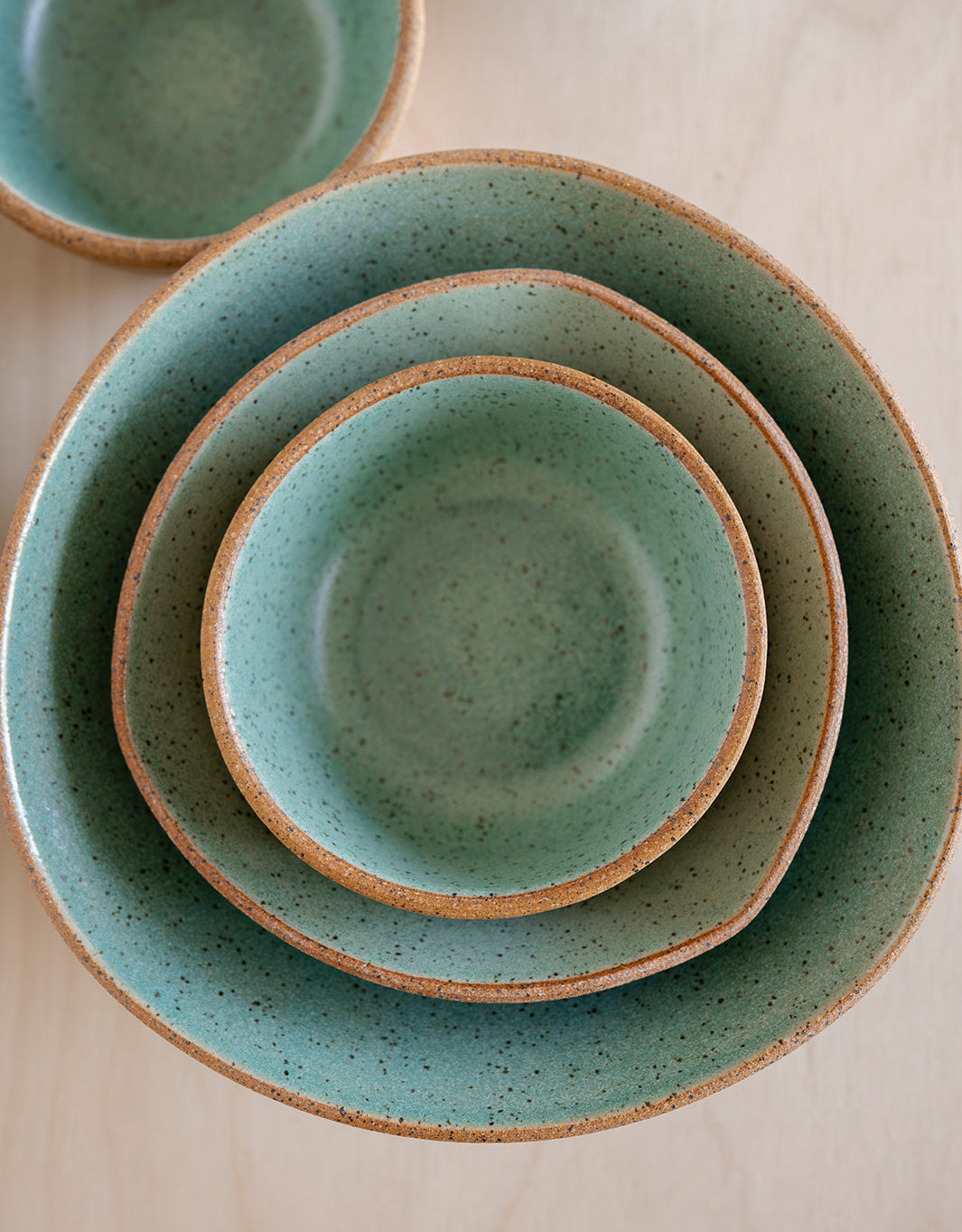 Set of Speckled Jaded Good Wheel Ceramics bowls. A Snack Bowl inside a Mini-triangle bowl inside of a Triangle bowl. Uniquely exposed raw clay rim. Dishwasher safe, made on Vancouver Island, Canada. 