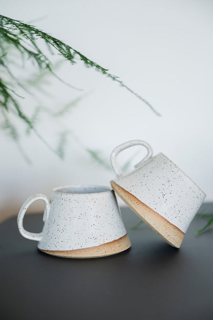 Handmade speckled white ceramic A-frame mug, uniquely tapered shape with two-finger handle. Wheel-thrown stoneware mug 12 oz, made on Vancouver Island, Canada