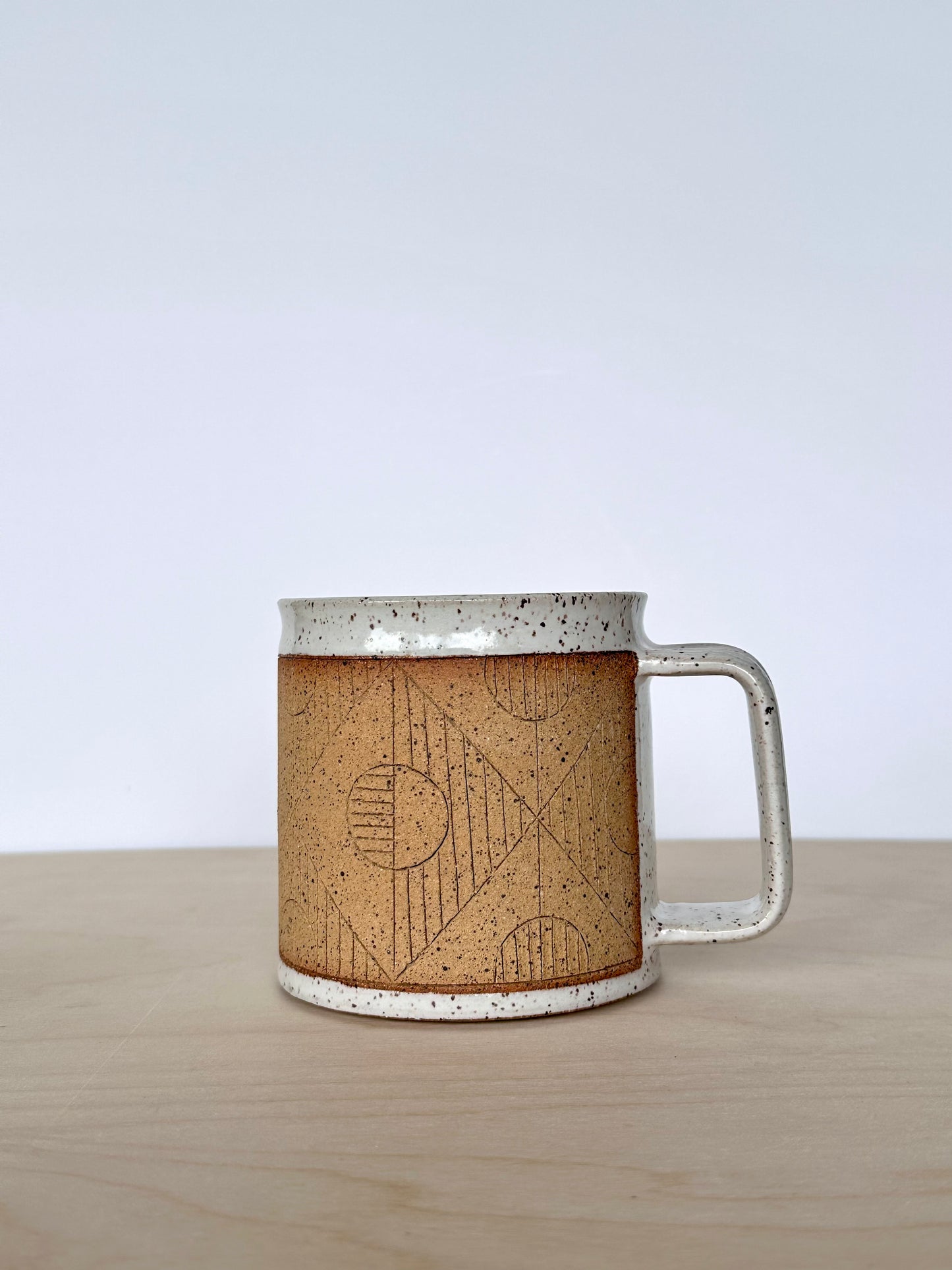 Handmade wheel-thrown ceramic mug with hand-carved circle pattern, 16 oz stoneware mug, unique pottery mug Vancouver Island, small-batch handmade ceramics Canada. Handle facing right. 